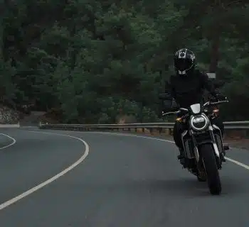 man riding motorcycle on concrete street