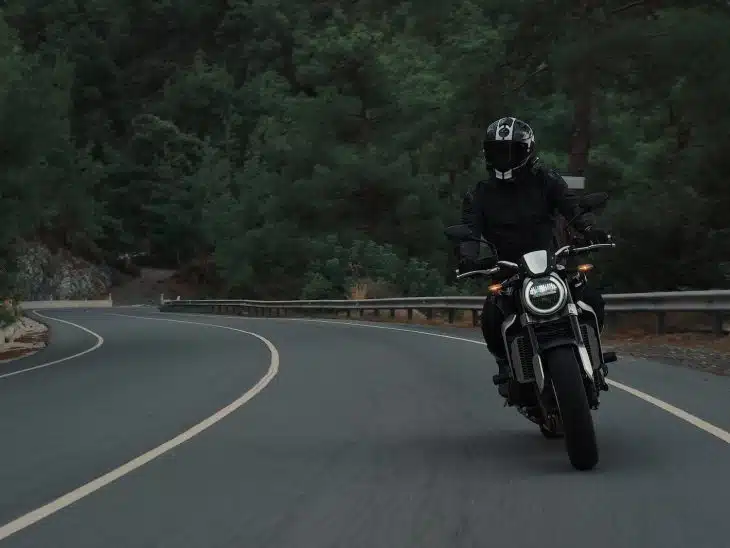 man riding motorcycle on concrete street