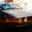 black car parked beside building